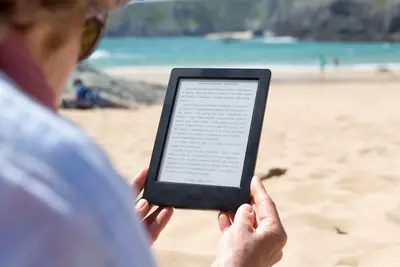 Woman reading book on Kindle