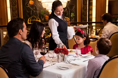 Waiter serving a family