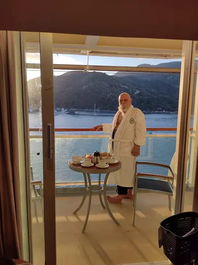 man standing on cruise balcony