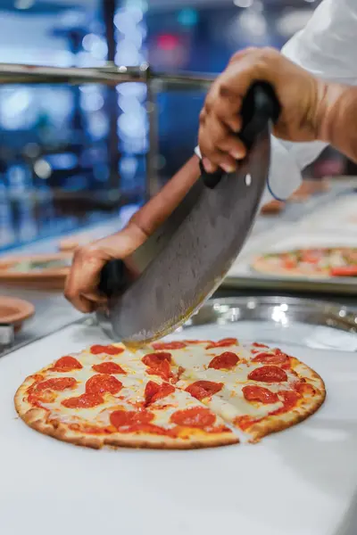 Pizza being sliced