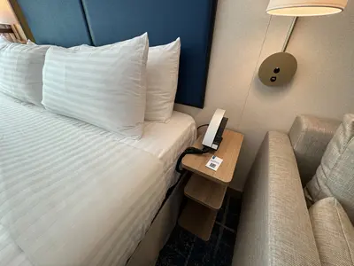Spacious Infinite Central Park Balcony Cabin bed side on Icon of the Seas