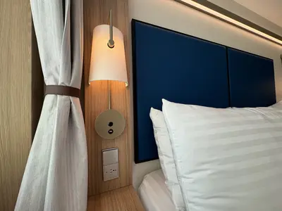 Spacious Infinite Central Park Balcony Cabin bed lights on Icon of the Seas