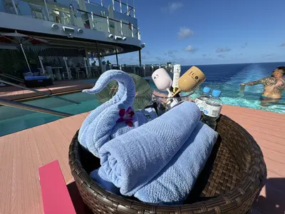 The Hideaway on Icon of the Seas daybeds include towels, water, and champagne