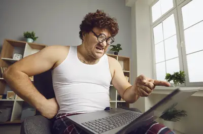 man points finger at laptop screen