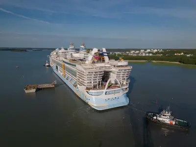 Icon of the Seas sailing away from shipyard