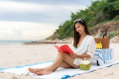 Woman on beach reading