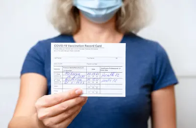 Woman with Covid-19 vaccine card