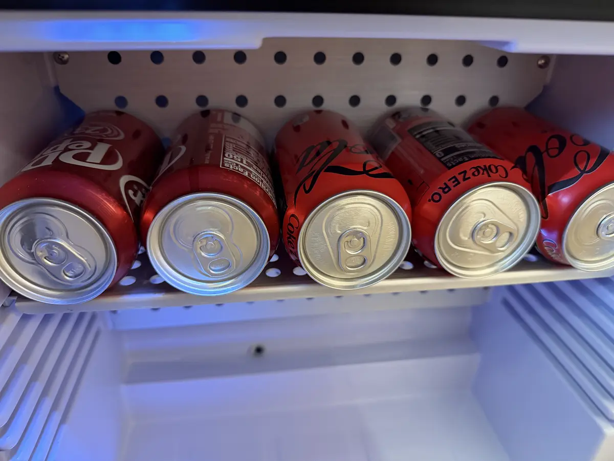 Cans of soda in the fridge