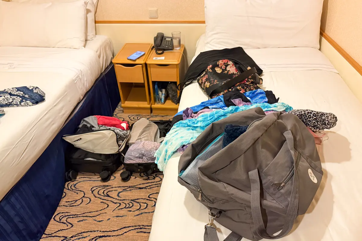 clutter on cruise ship bed and floor