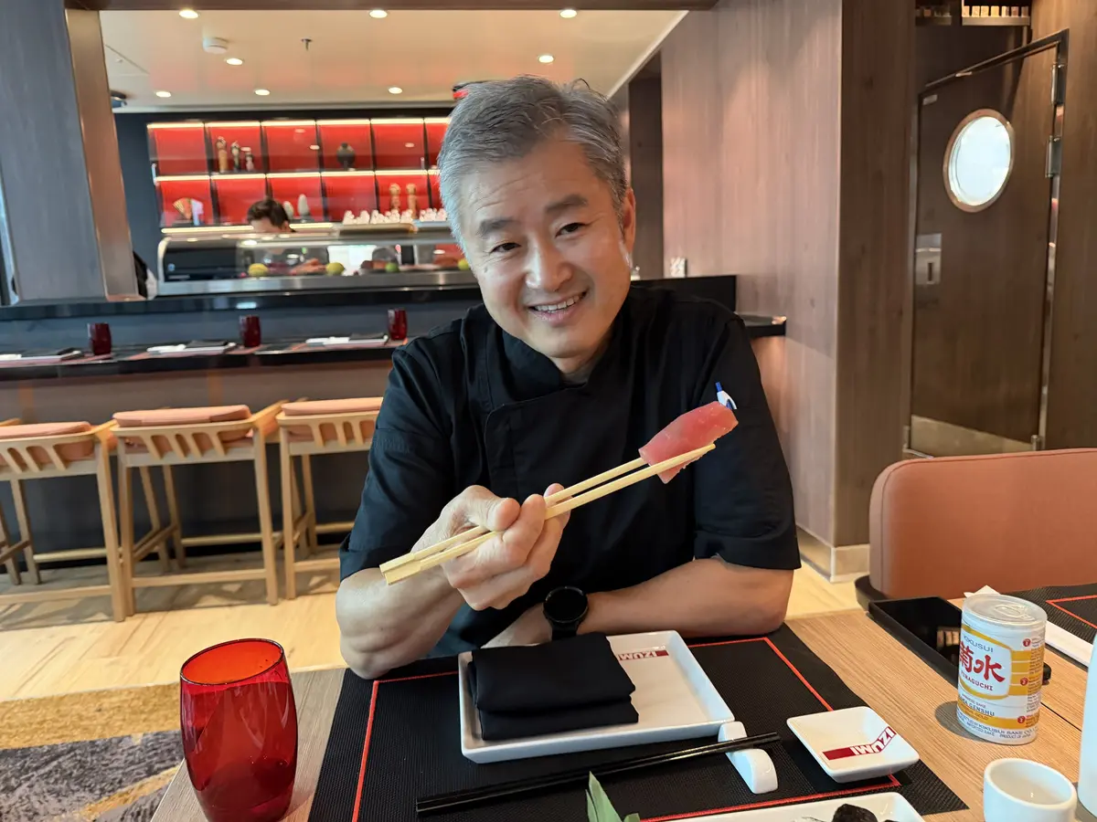 Chef Travis holding sushi