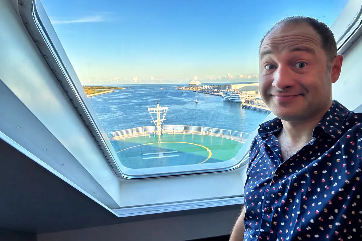 Matt in front of a cabin window