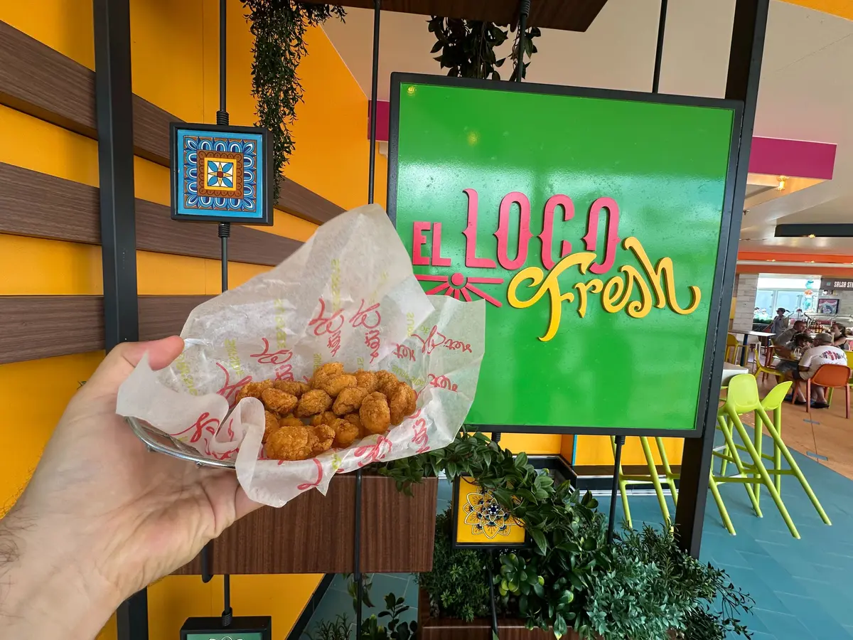 Popcorn chicken in front of El Loco Fresh sign