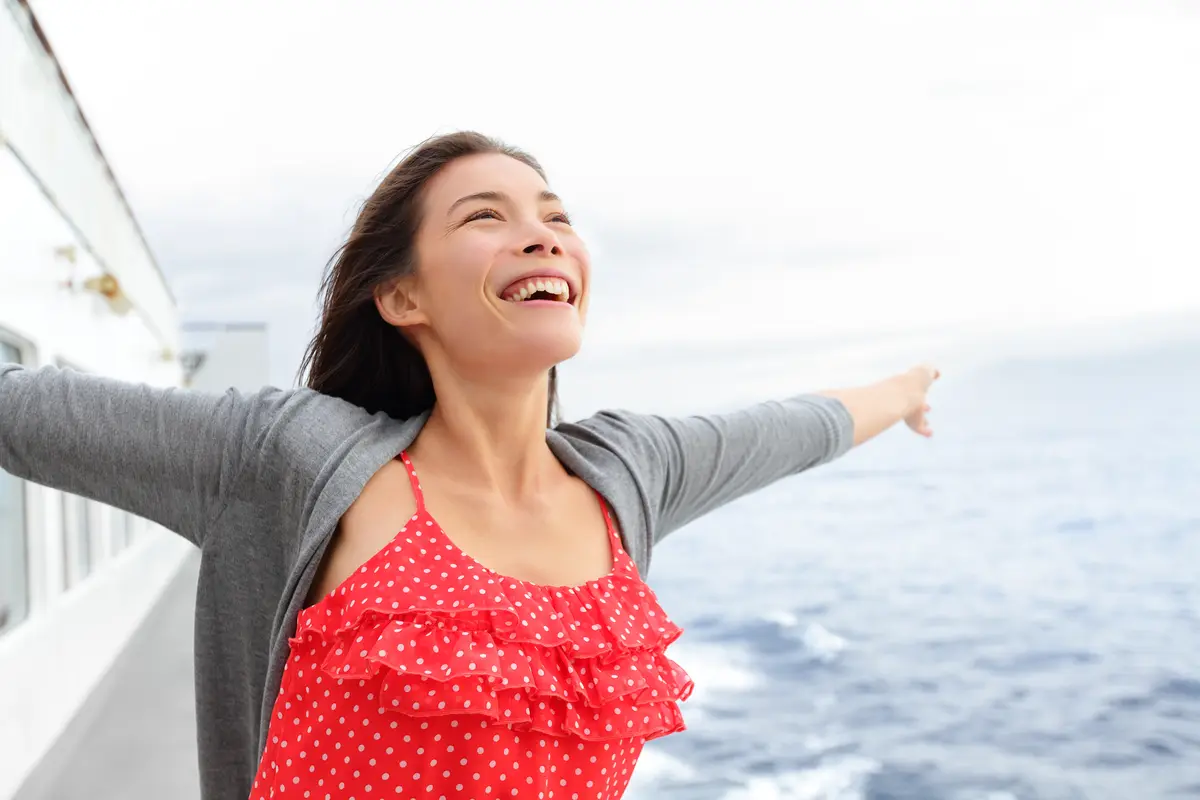 Woman happy on a cruise ship